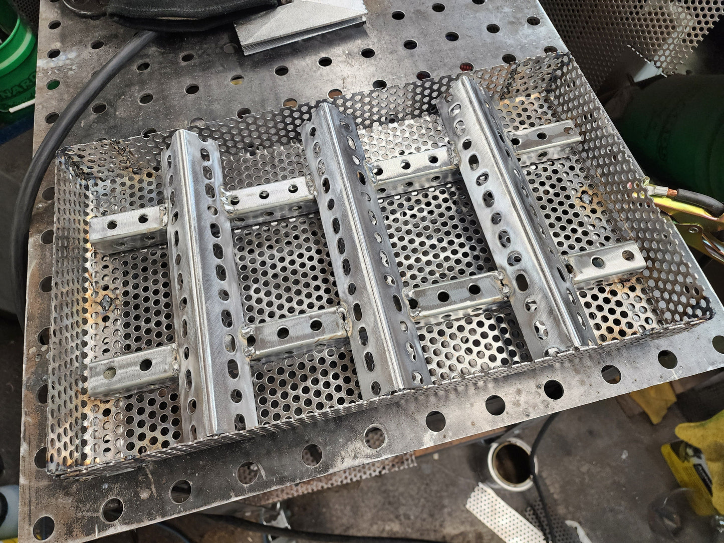 11" x 17" wood pellet insert in a perforated metal basket from a slight angle