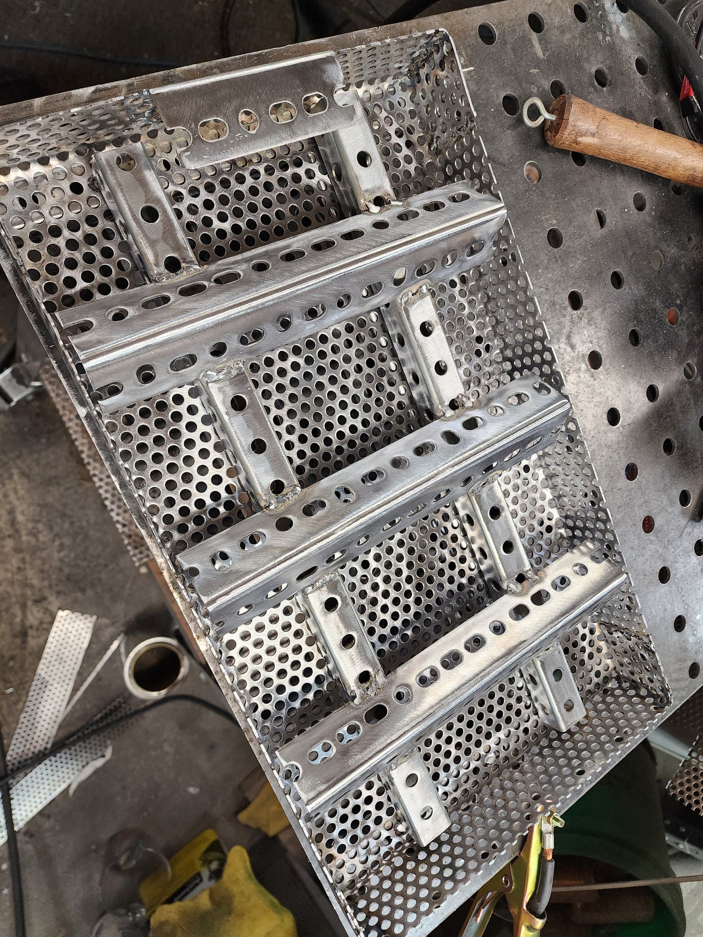 11" x 17" wood pellet insert in a perforated metal basket from a slight overhead angle