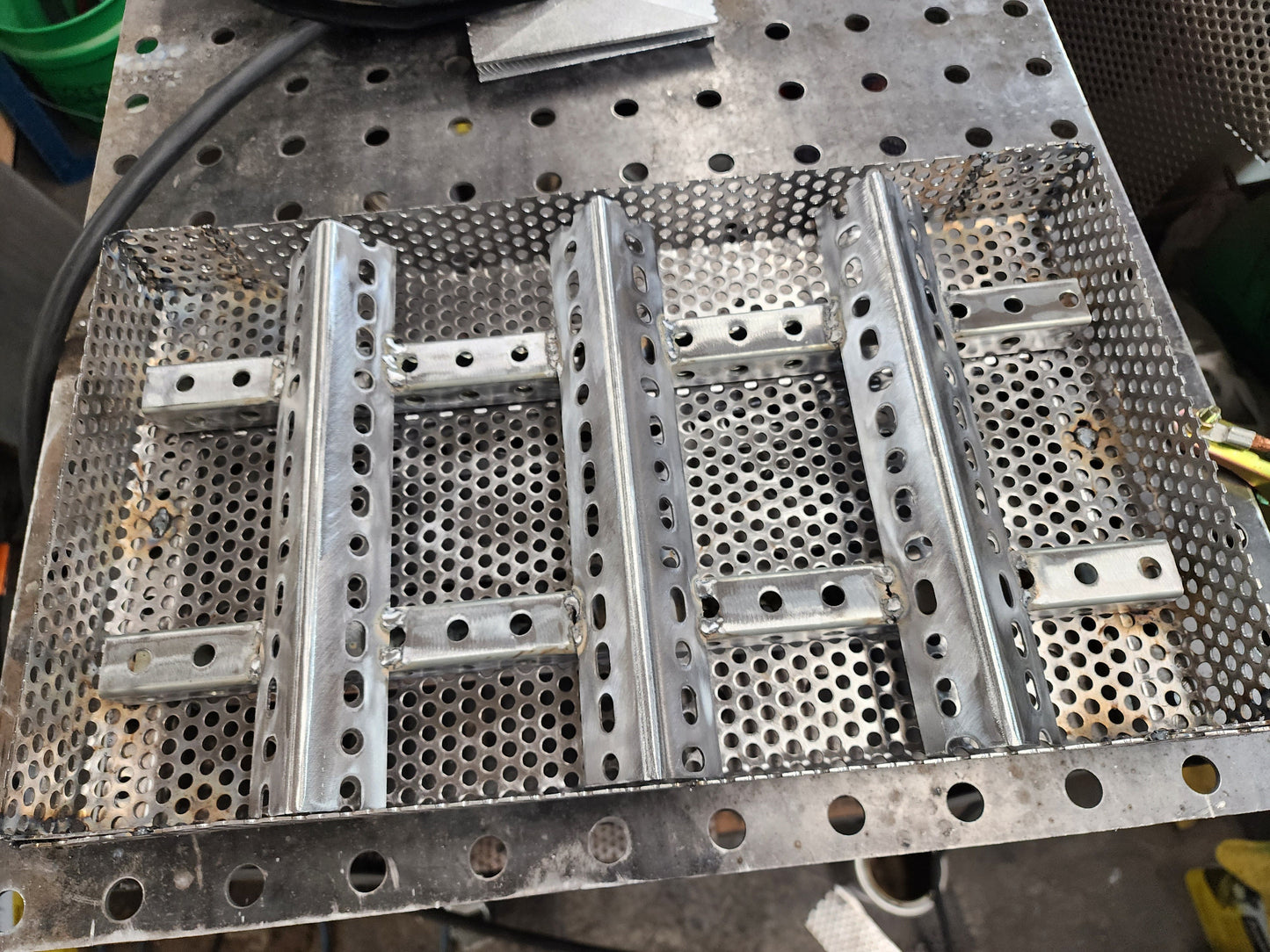 11" x 17" wood pellet insert in a perforated metal basket from a slight angle