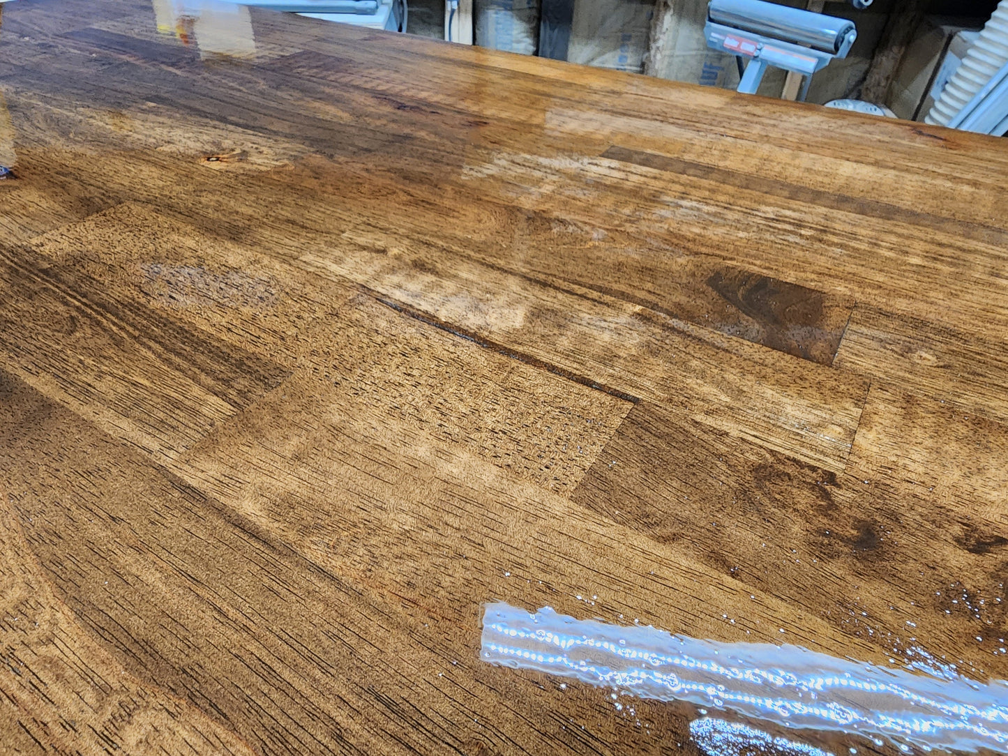 Butcher block countertop close-up: warm brown wood with rich grain, glossy finish, 1.5-inch thick surface.