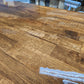 Butcher block countertop close-up: warm brown wood with rich grain, glossy finish, 1.5-inch thick surface.